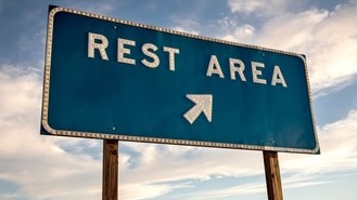 Blue rest area highway sign with arrow
