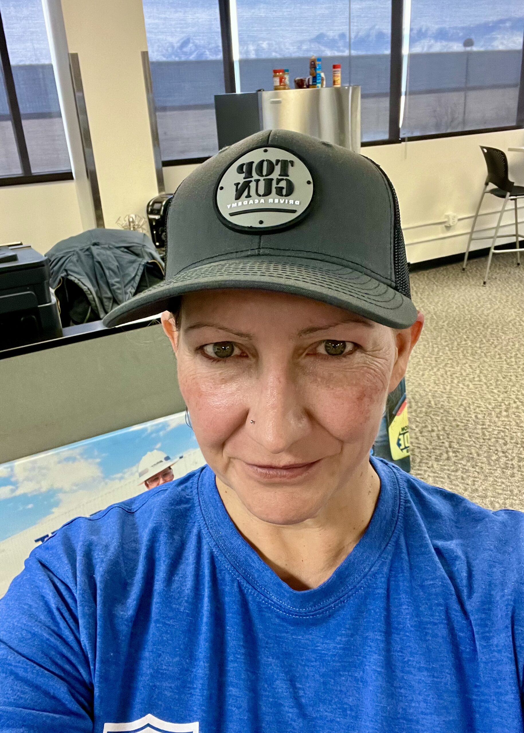 E in a Top Gun Driver Academy hat