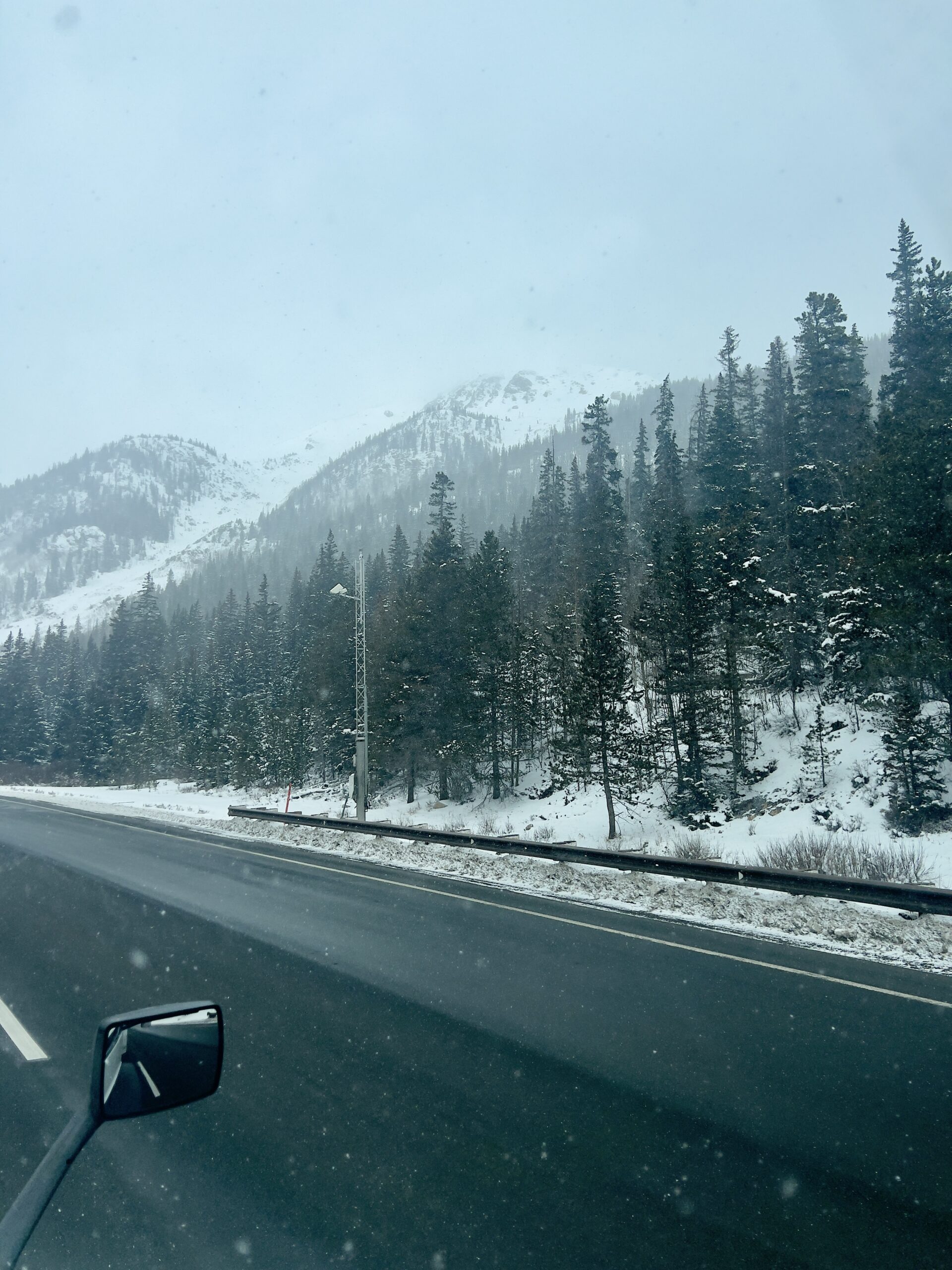 Snowy mountain pass in Colorado in May, view from the cab