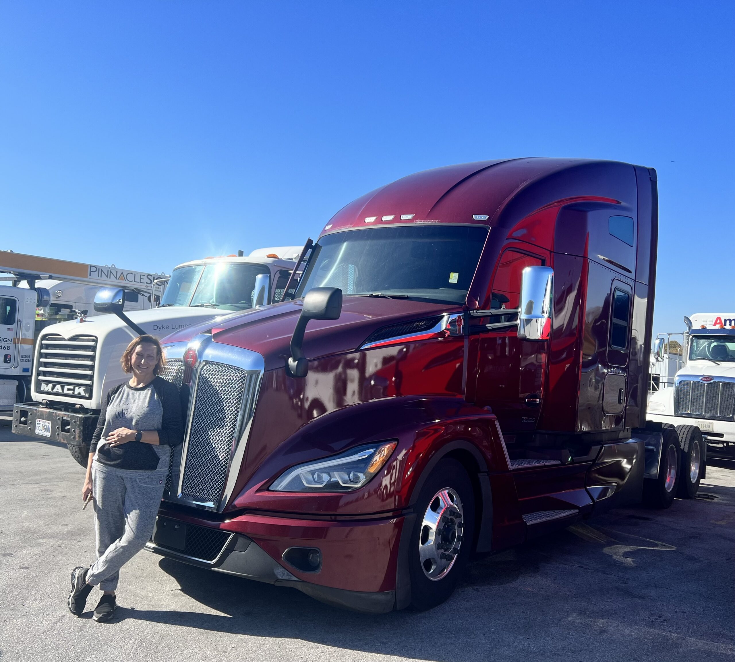 E standing next to the first M2GT truck, a 2023 Kenworth T680, on the day it was purchased